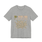 Gray t-shirt with gold graphic and text on a white background